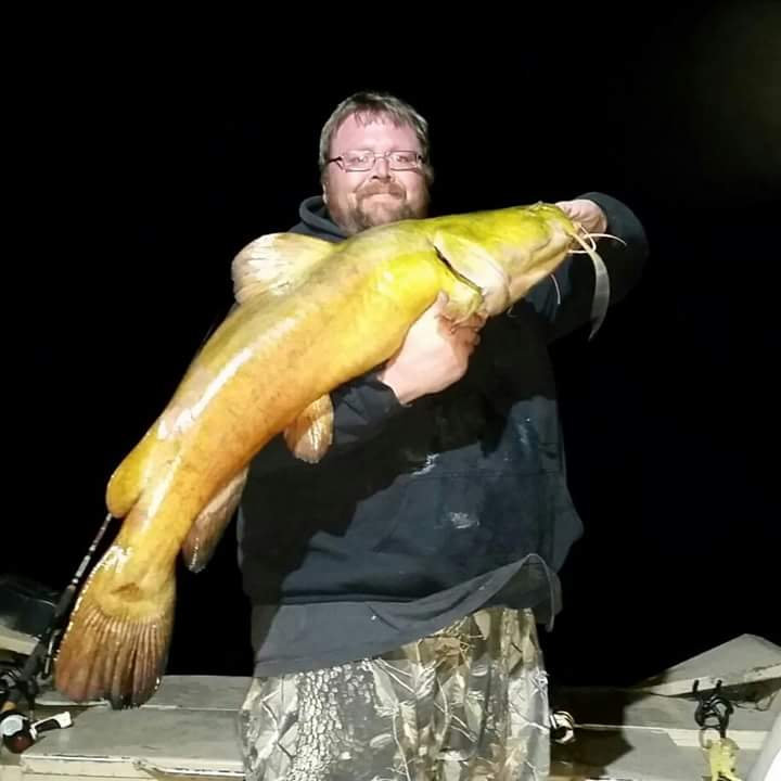 Jason Hill hold a flathead catfish